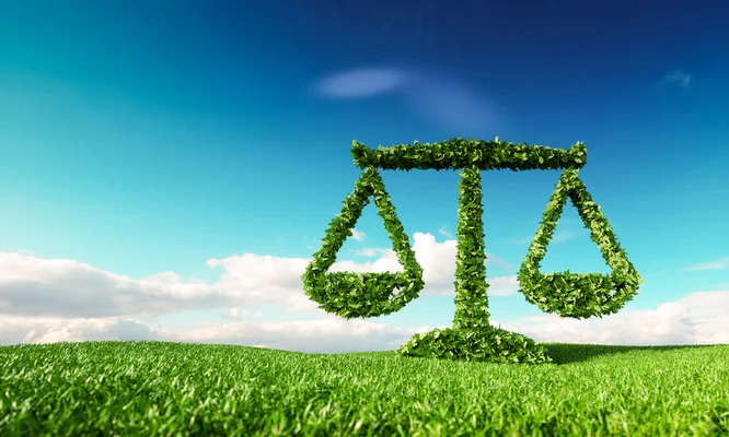 Eco friendly law, politics and eco balance concept. 3d rendering of scale icon on fresh spring meadow with blue sky in background.