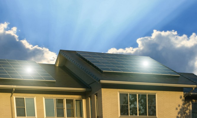 Green energy of solar cell panel on house roof in blue sky and sunlight